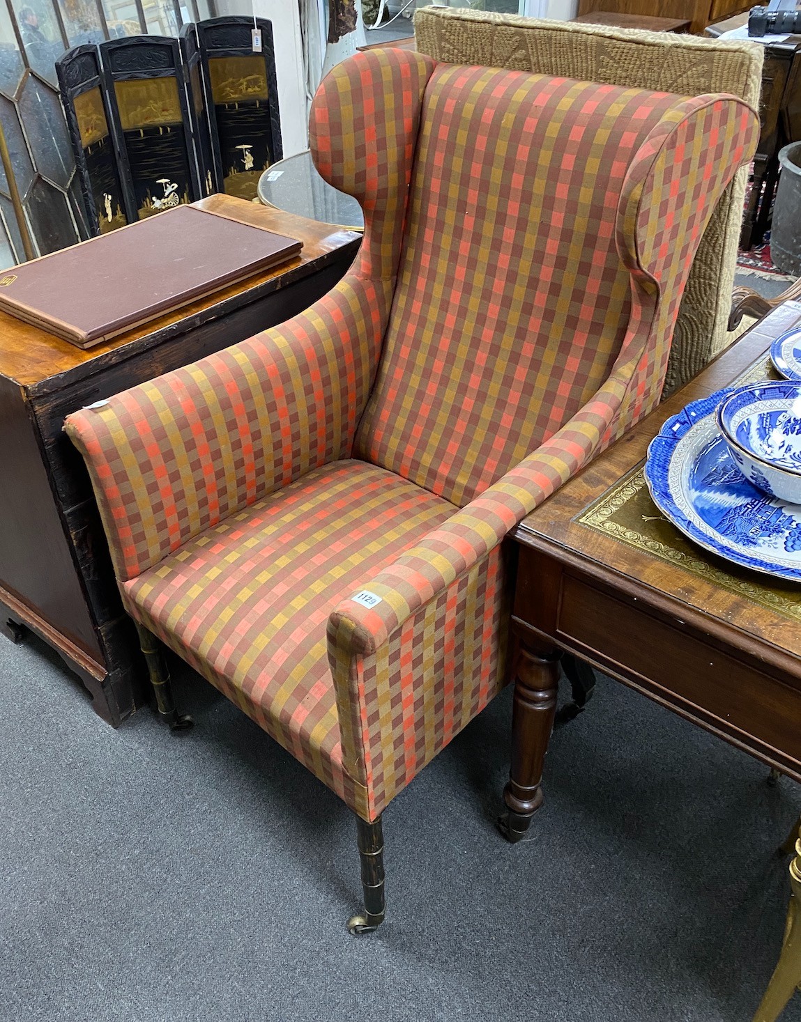 A Regency upholstered simulated coromandel wing armchair on faux bamboo legs, width 67cm, depth 88cm, height 116cm